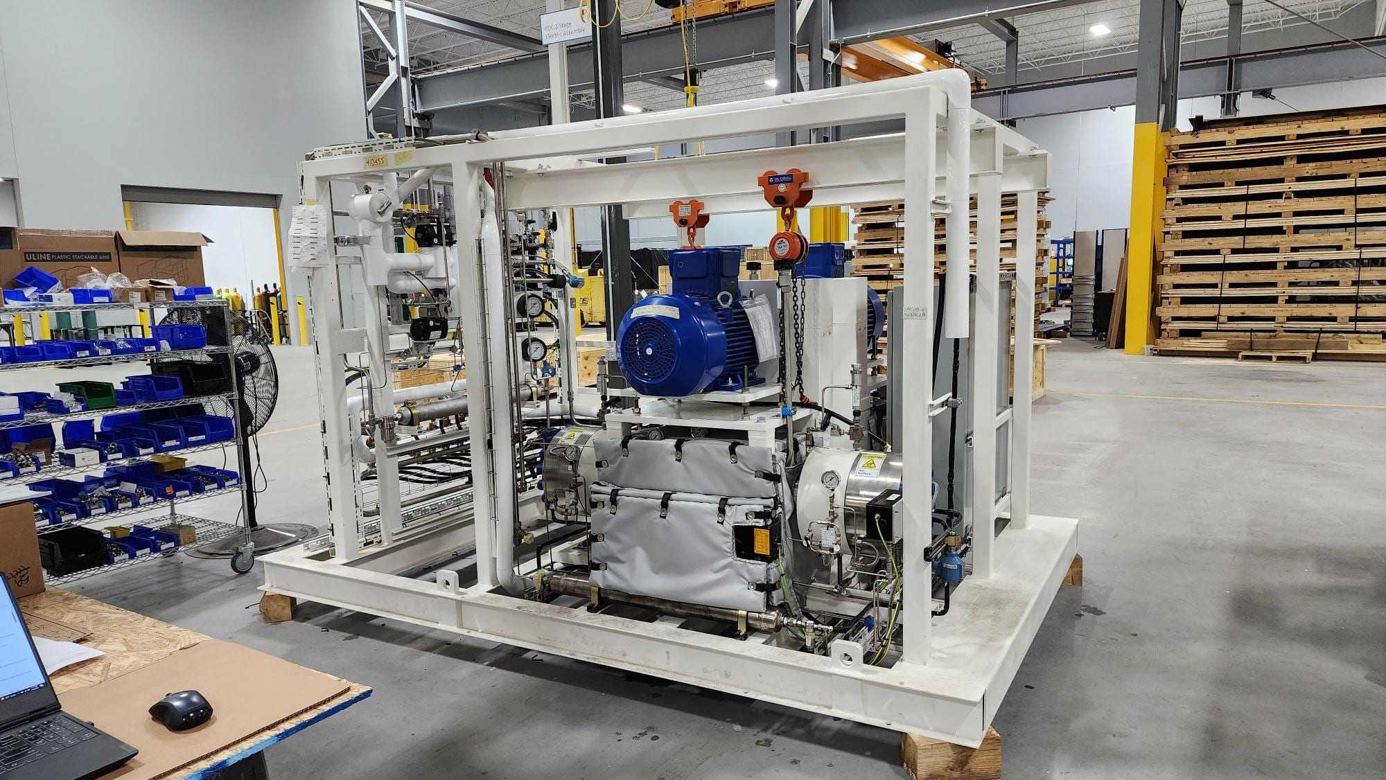 Compressor skid with motor and instrumentation in a workshop