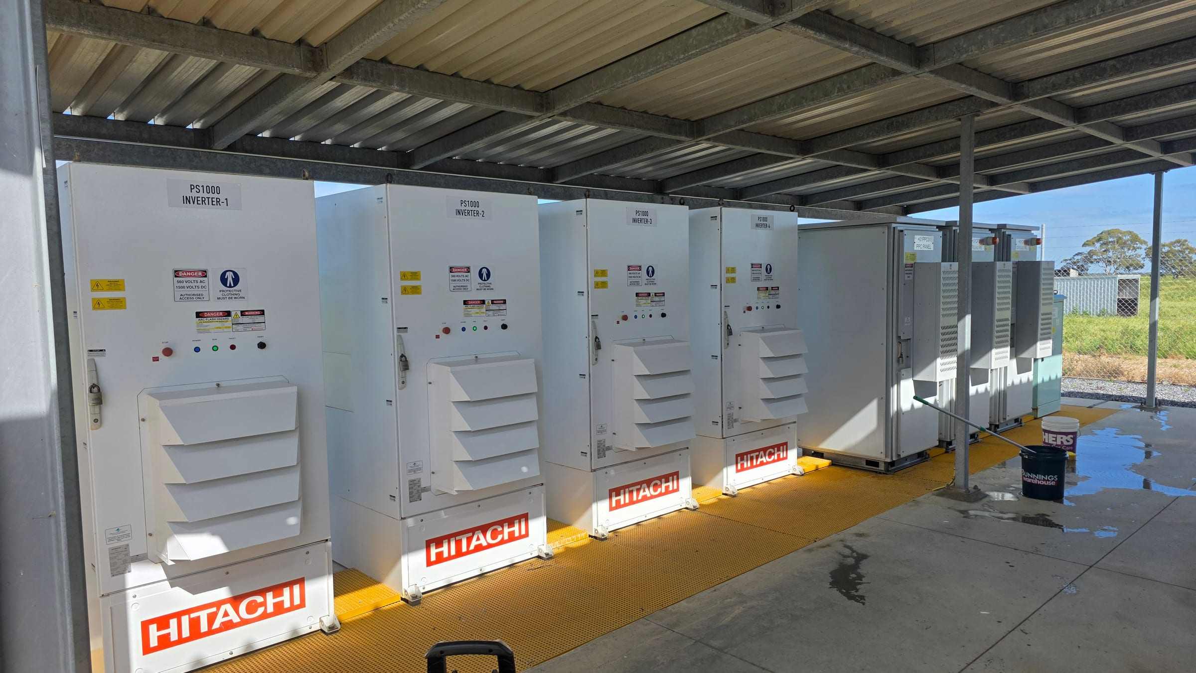 Row of inverter units under a canopy at an energy site