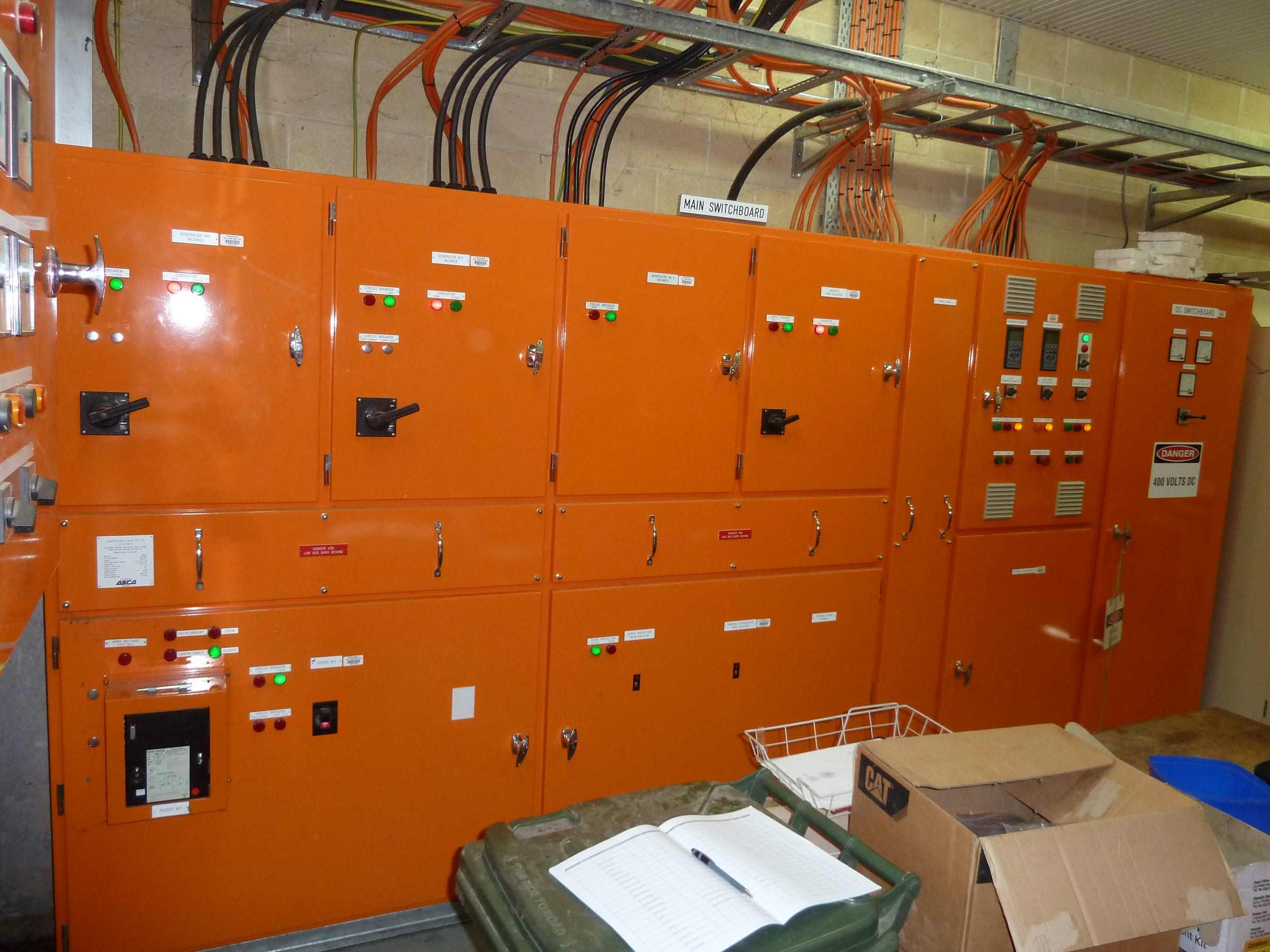 Orange motor control centre panels in a plant room