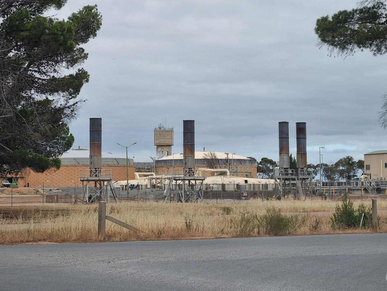 Gas power station exhaust stacks behind a fence line