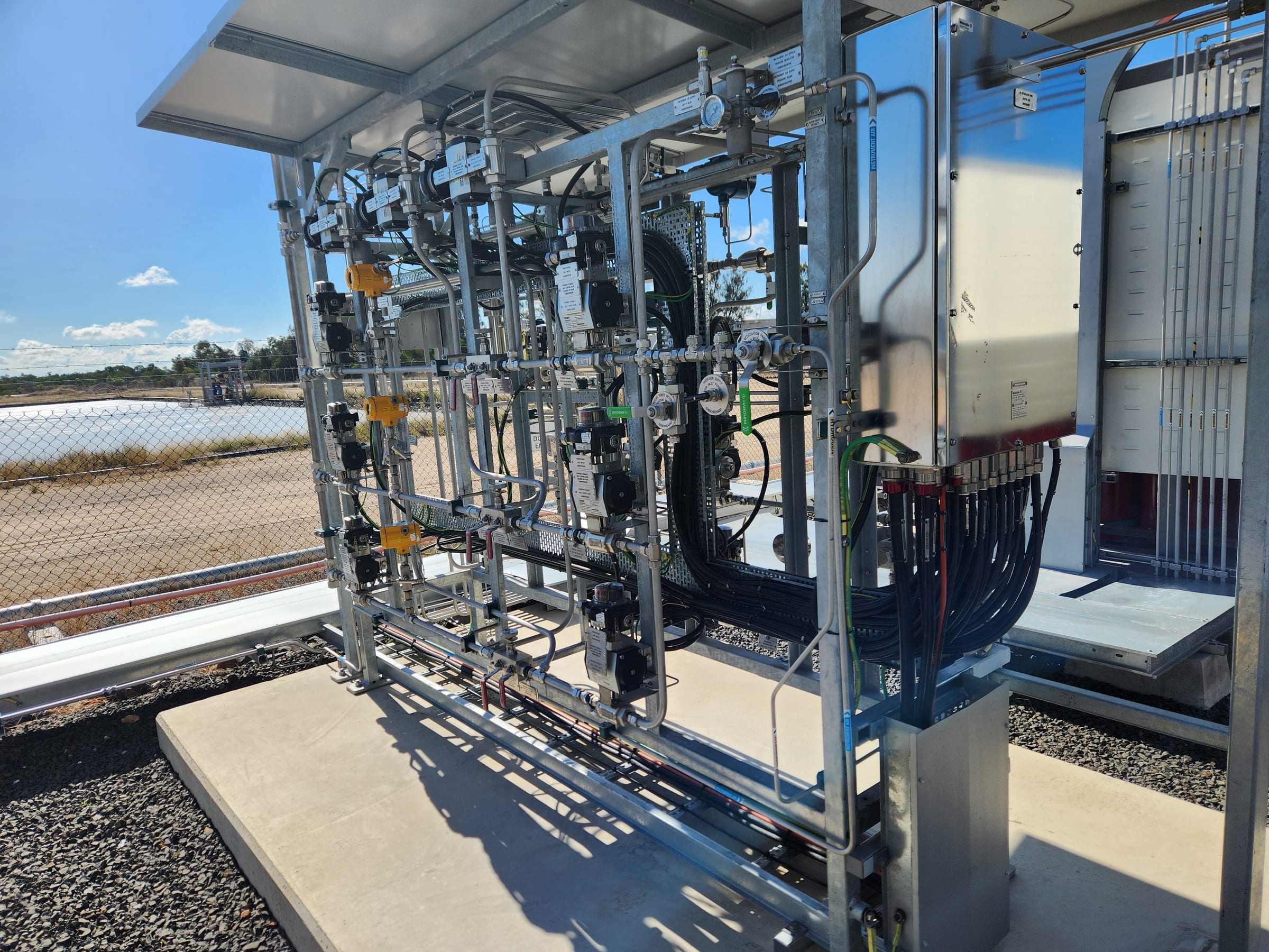 Outdoor process pipework and instrument rack under a canopy
