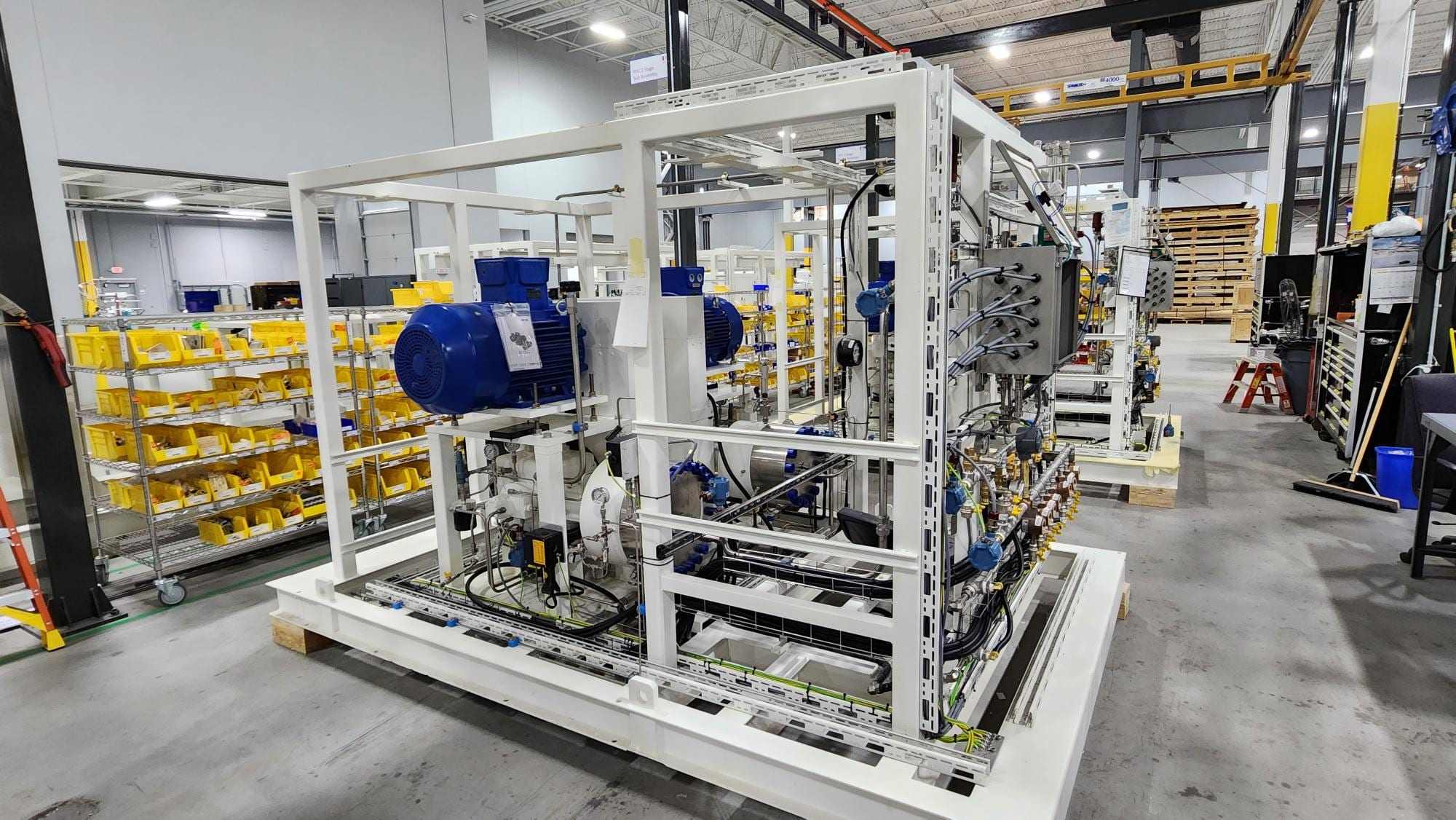 Fabricated process skid with motor and pipework in a workshop