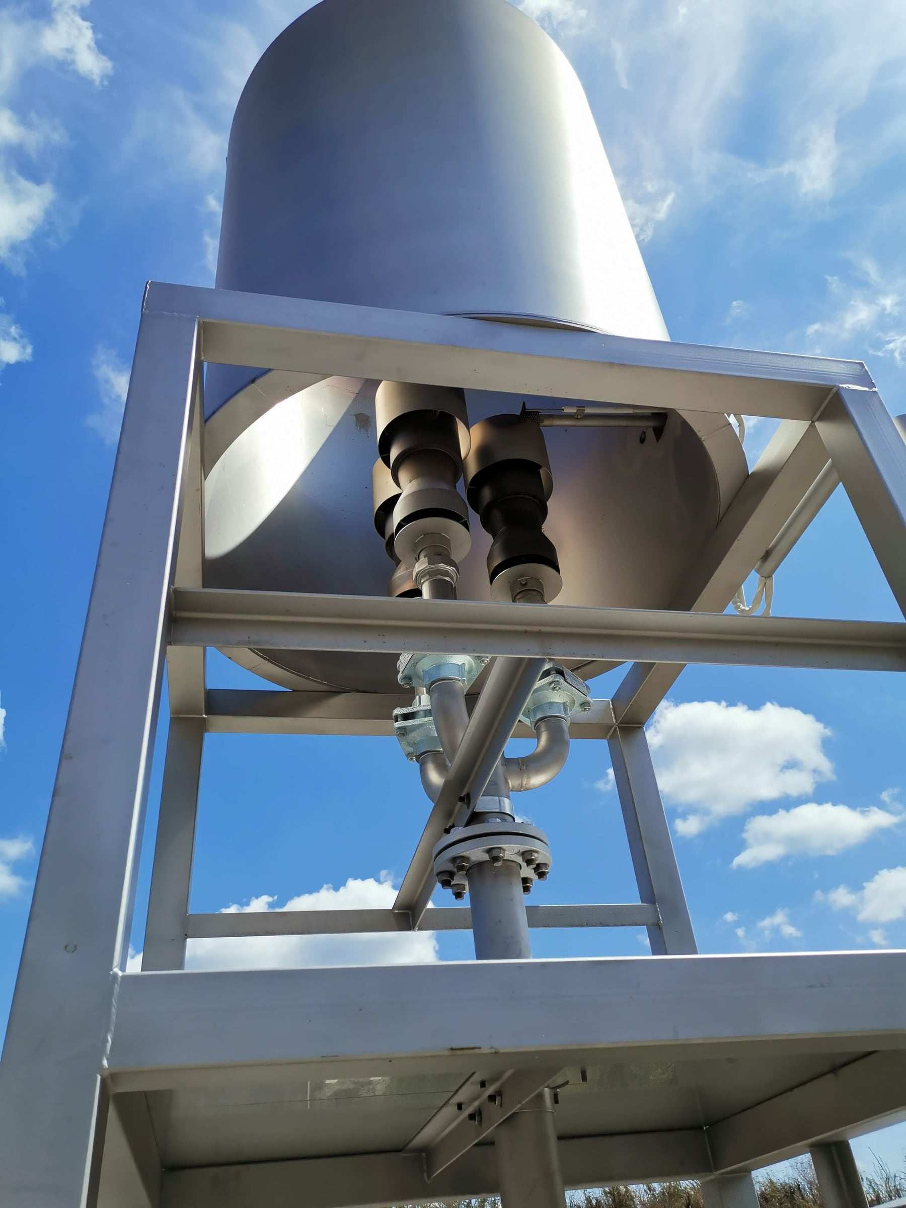 Process vessel mounted in a steel frame against a blue sky