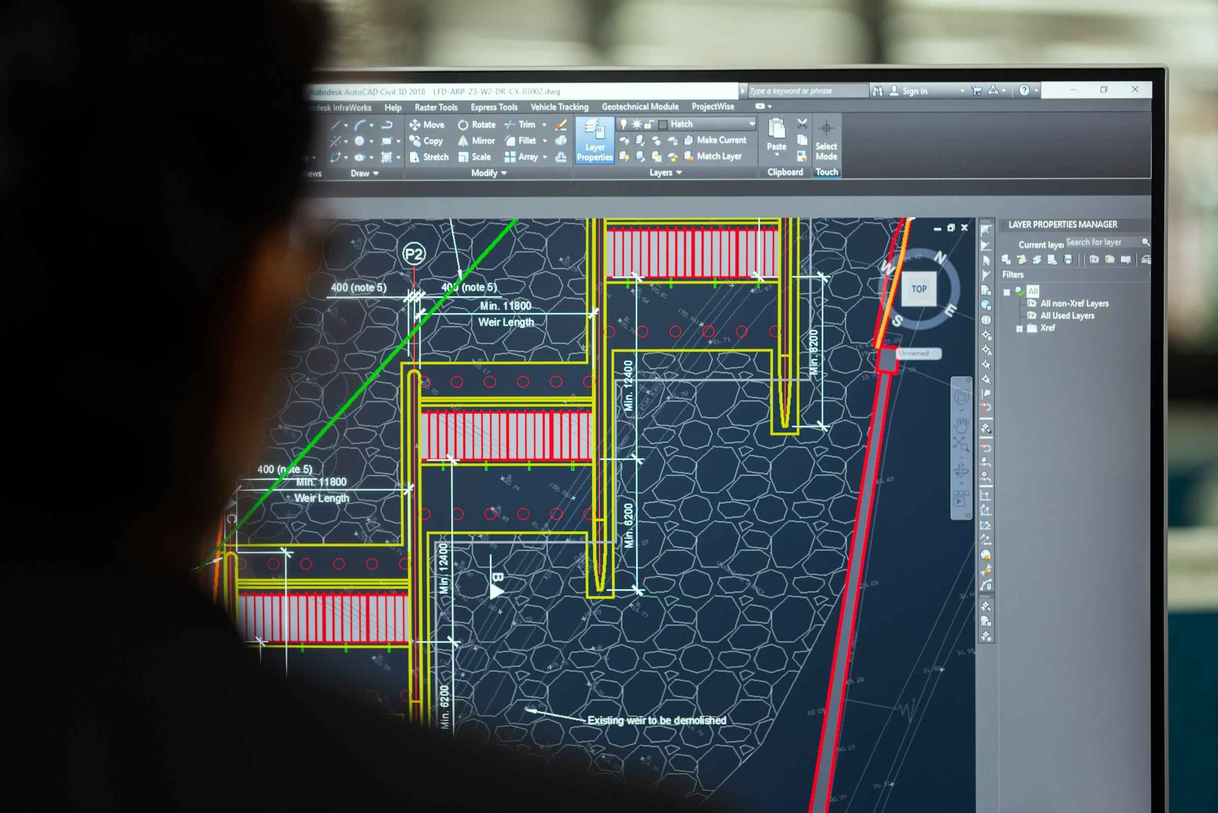 Engineering drawing open in CAD software on a monitor