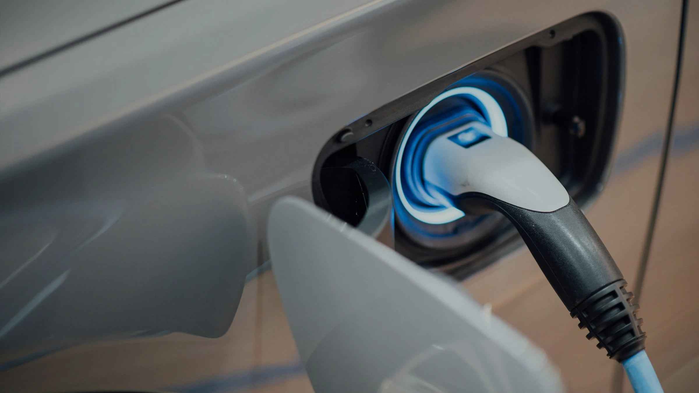 Electric vehicle plugged in at a charging station