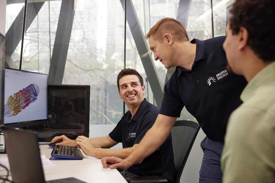 Amarna engineers discussing a simulation model on screen