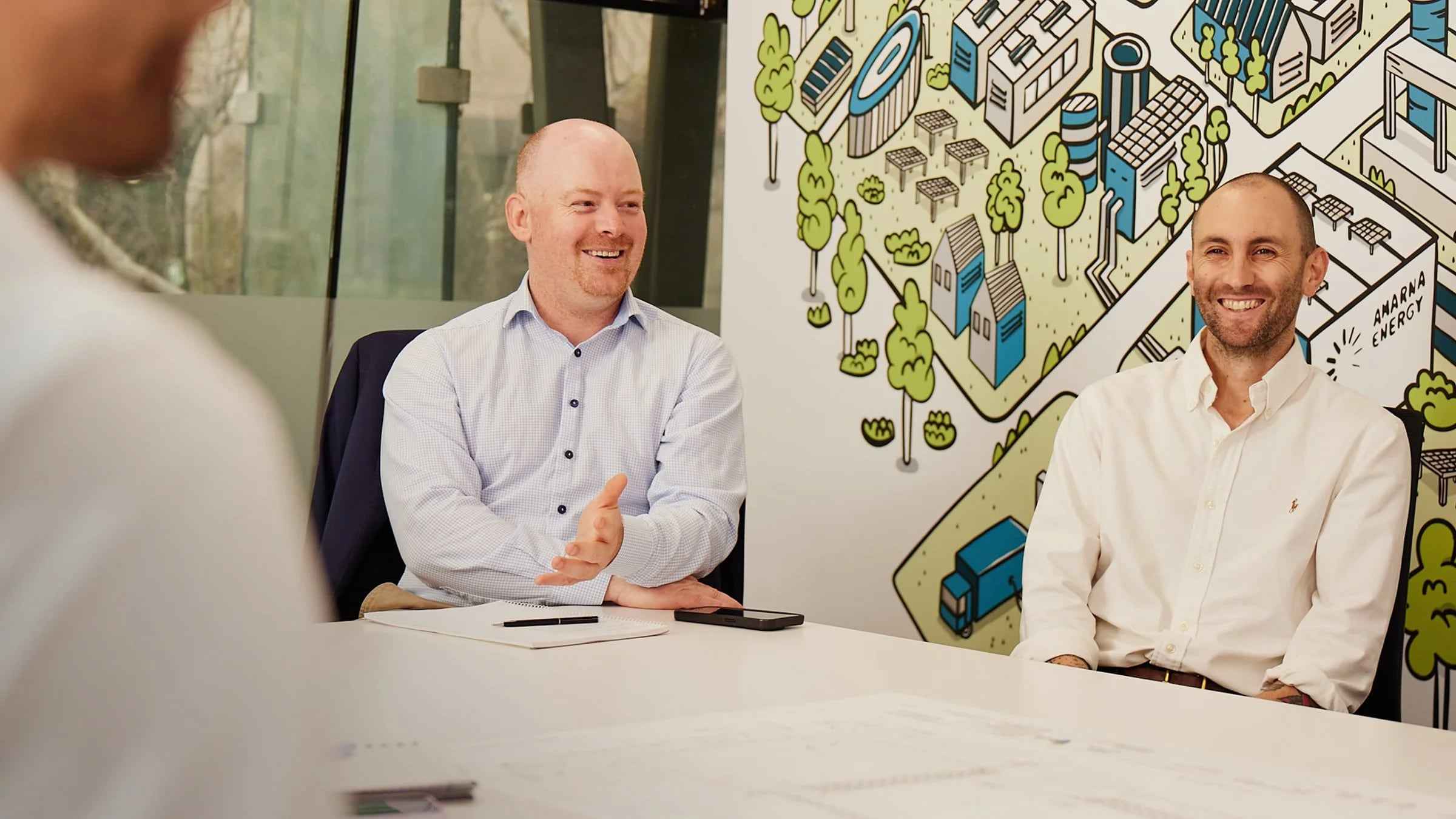Amarna engineers smiling during a meeting in the Sydney office