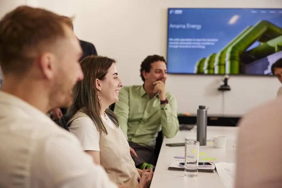 Amarna engineers in a meeting, with a presentation on the screen behind them